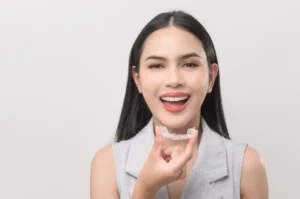 Adult woman smiling confidently with clear aligners